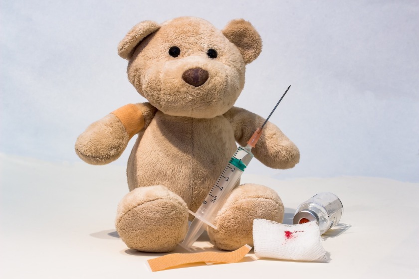 teddy bear with a syringe and vial
